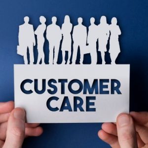 Paper cut out of people and text reading customer care